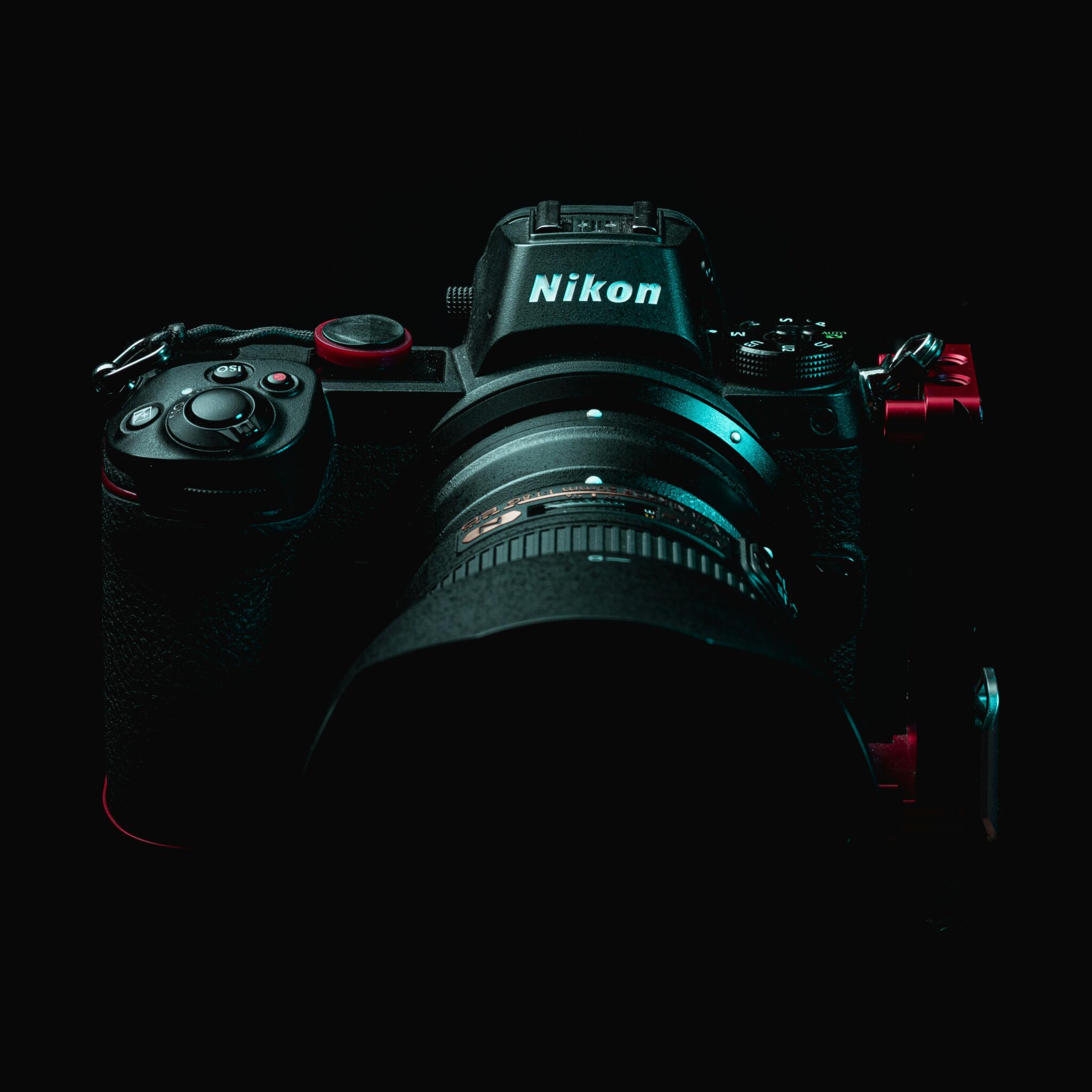 Close-up shot of a professional Nikon DSLR camera in a dimly lit setting.