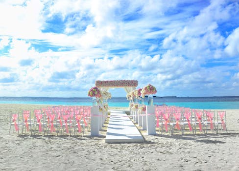 Elegant beach wedding setup in Maldives with floral decor and ocean view.