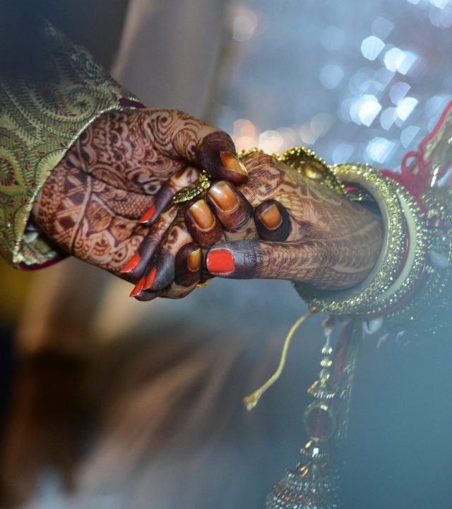 A beautiful capture of mehndi-decorated hands symbolizing love and tradition in a wedding ceremony.